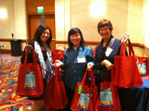 Volunteers distribute the bags to conference attendees.
