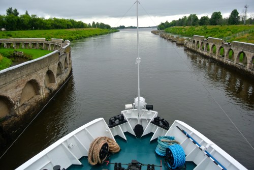On the ship’s prow, traveling along the Russian waterways.
