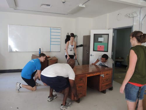 How many Penn alumni does it take to lift this heavy desk onto a dolly?
