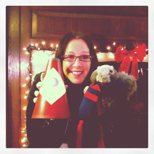 Elise showing three examples--a mini-megaphone, a Homecoming Weekend scarf, and a squirrel puppet we used for a holiday card video. 