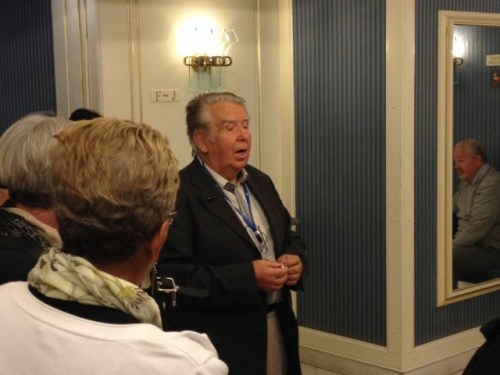 Dana Jolley, Linda Freeman, and, in reflection, Bill Koch listening to Vaclav Bechyni singing the Czech  national anthem.  