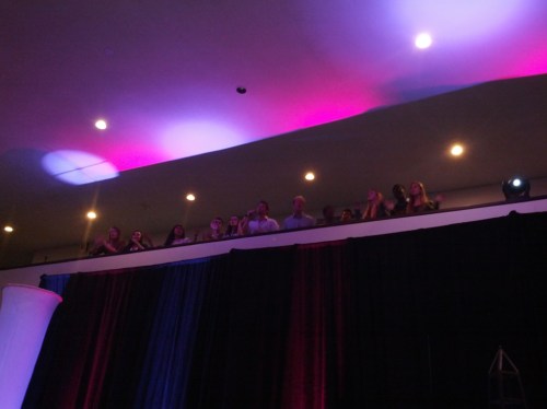 Penn student a cappella group singing from the balcony of the Annenberg Lobby