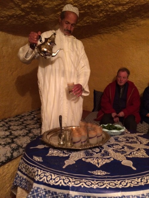 Muhammad pours mint tea from a great height.