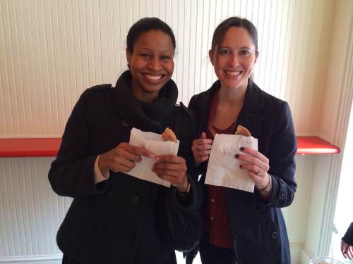Nicole and Molly enjoy a warm donut.