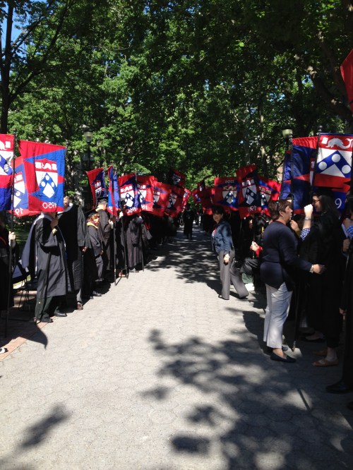 Alumni flag bearers line Locust Walk to congratulate the newest Penn Alumni!