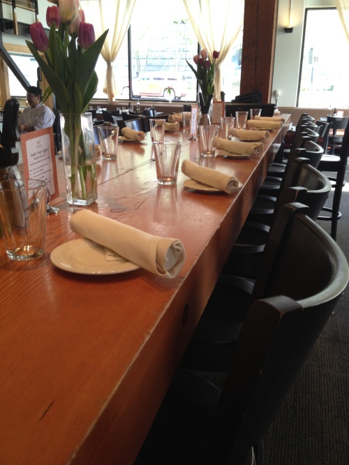 The tables are set for FareStart's Guest Chef Night, with Penn Alumni Club of Seattle members as guest servers.