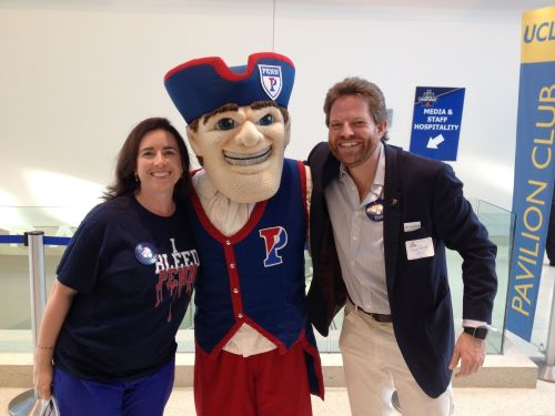 Kiera Reilly and Jordan Rockwell pose with the Penn Athletics mascot the Quaker at UCLA's Pauley Pavilion
