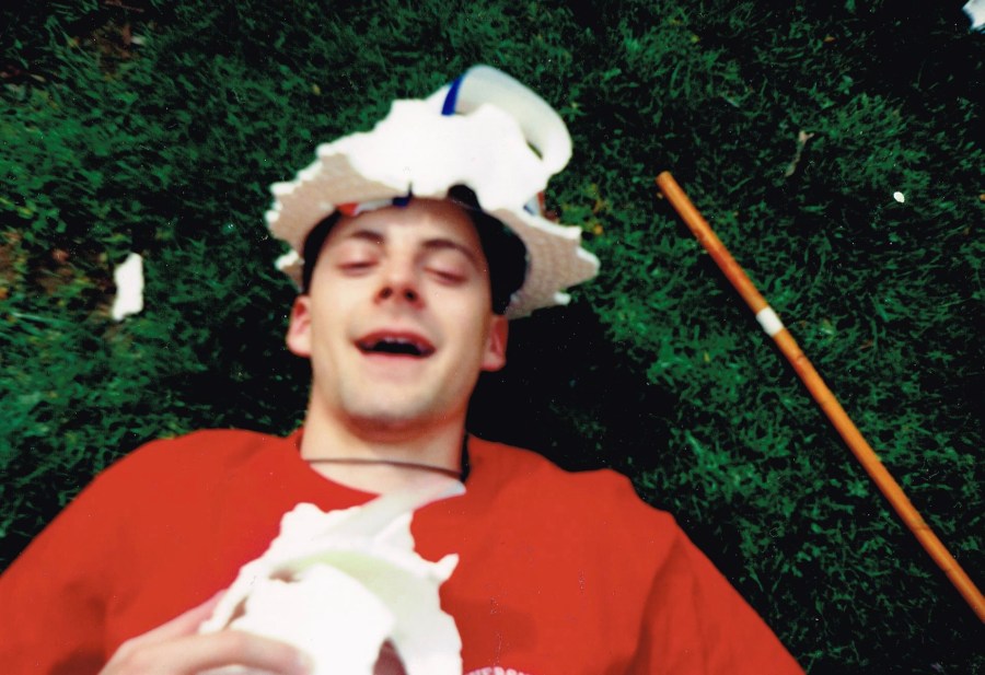 Relaxing on the grass is Justin Sowers, SEAS '93, photo courtesy of Jeff Liebert, CAS'93