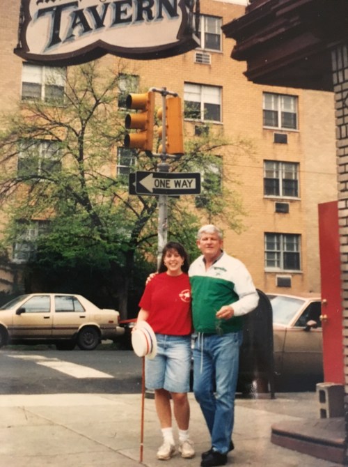 Julie Berliner Bell poses outside of Murphy's Tavern with Murph himself!