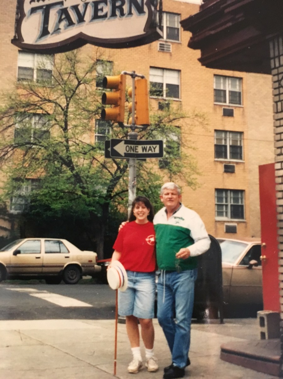 Julie Berliner Bell poses outside of Murphy's Tavern with Murph himself!